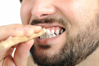 man-cleaning-teeth-miswak-stick.jpg.653x0_q80_crop-smart